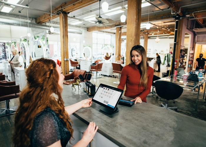 Small business owner completing a sale at an online-connected point of sale